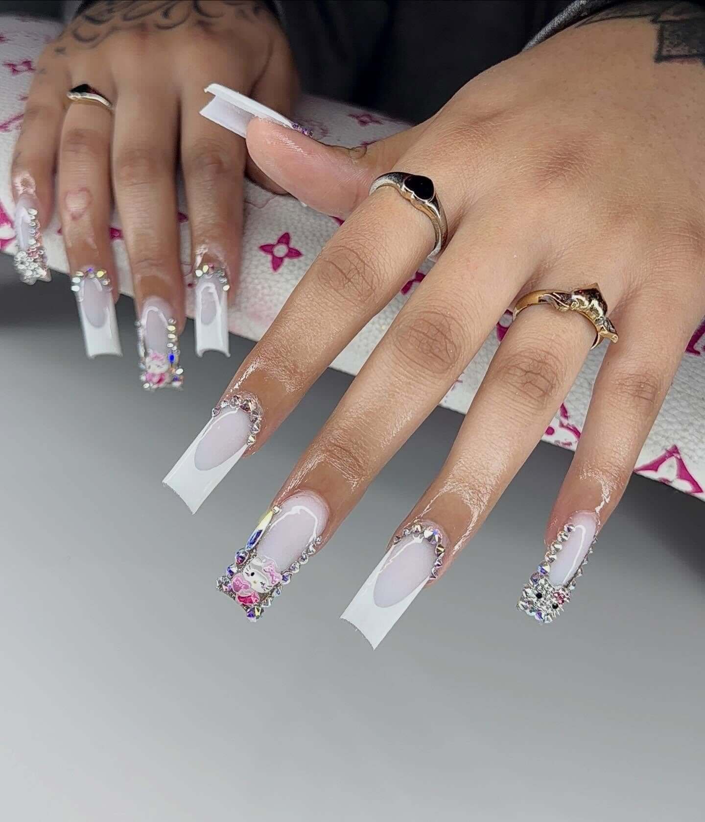 acrylic.diivaa French Tip Nails Covered in Rhinestones with a Charm Accent French Tip Nails Covered in Rhinestones with a Charm Accent