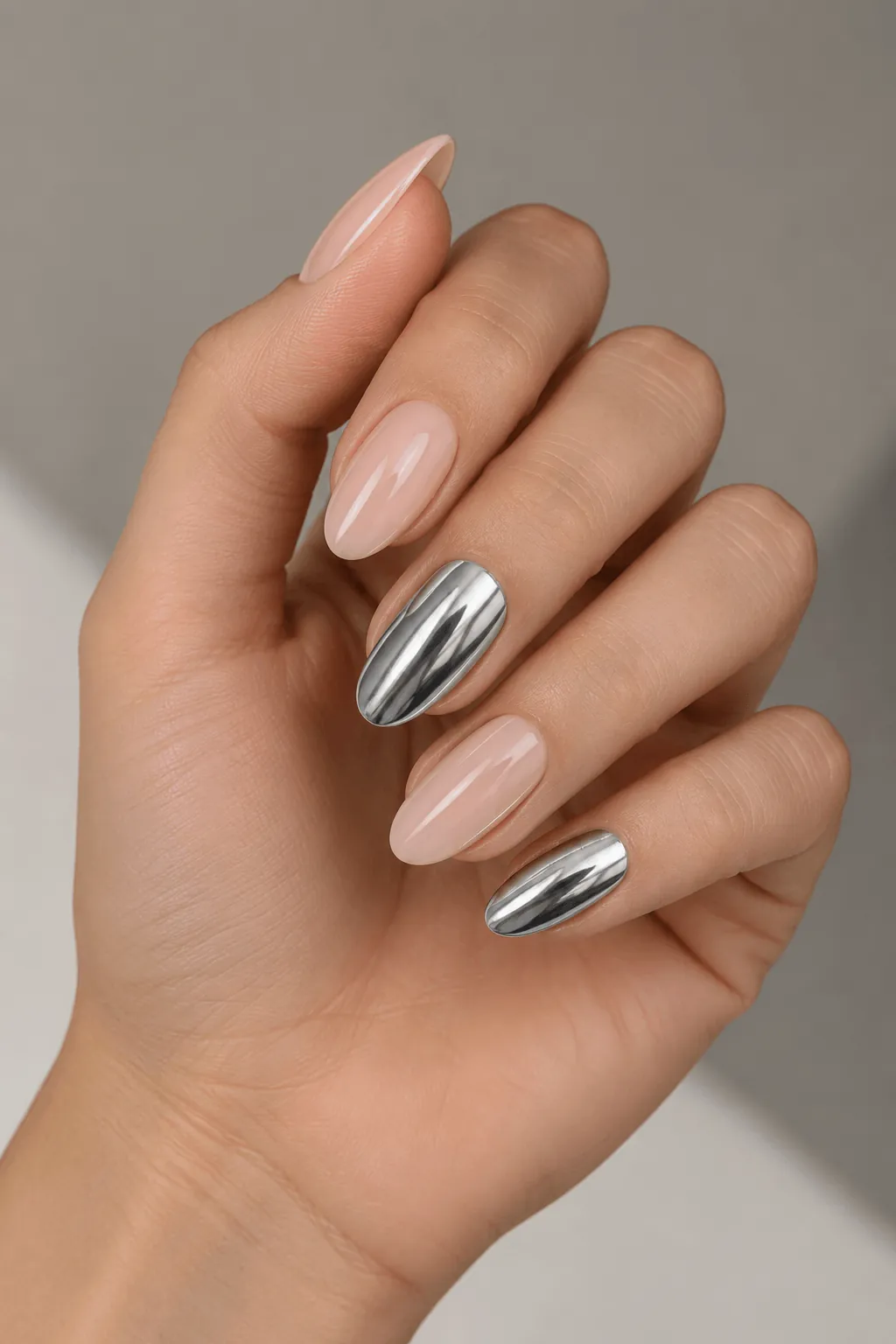 Chrome Accent Nail Ideas Nude almond nails with silver chrome accent nails