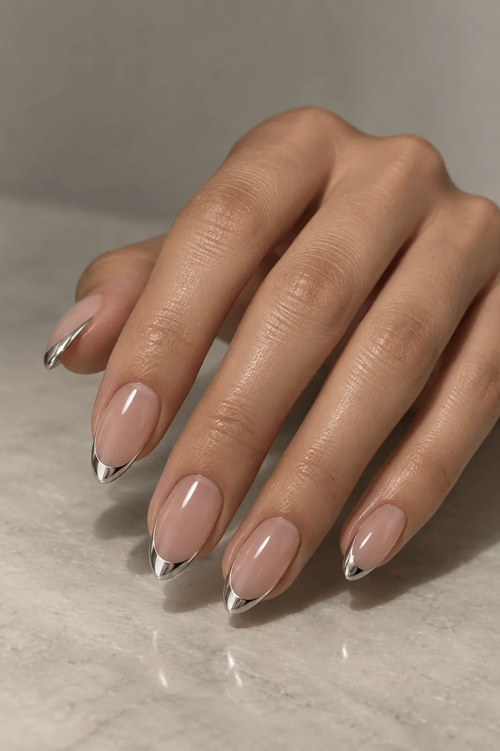 Chrome French Tips Chrome French tip nails with thin silver tips on a nude base