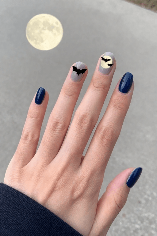 Full Moon and Bat Silhouette Scene Halloween nail art with a full moon and bat silhouette scene
