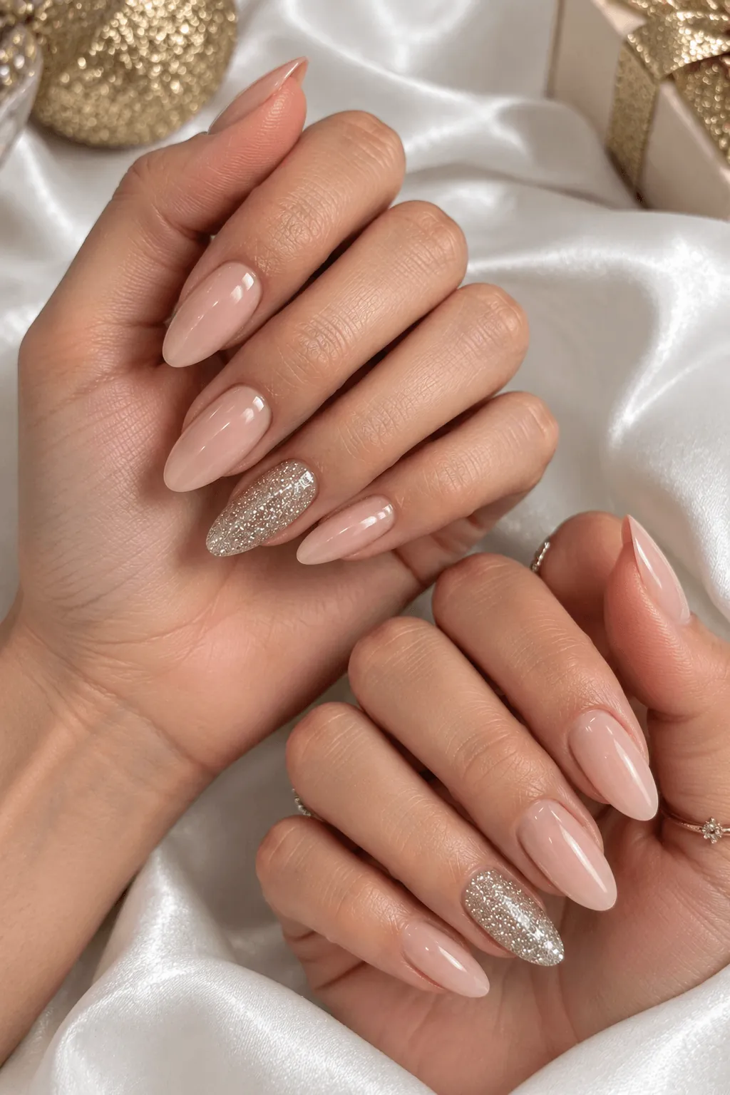 Glitter Gel Nail Ideas Nude almond gel nails with a silver glitter accent nail
