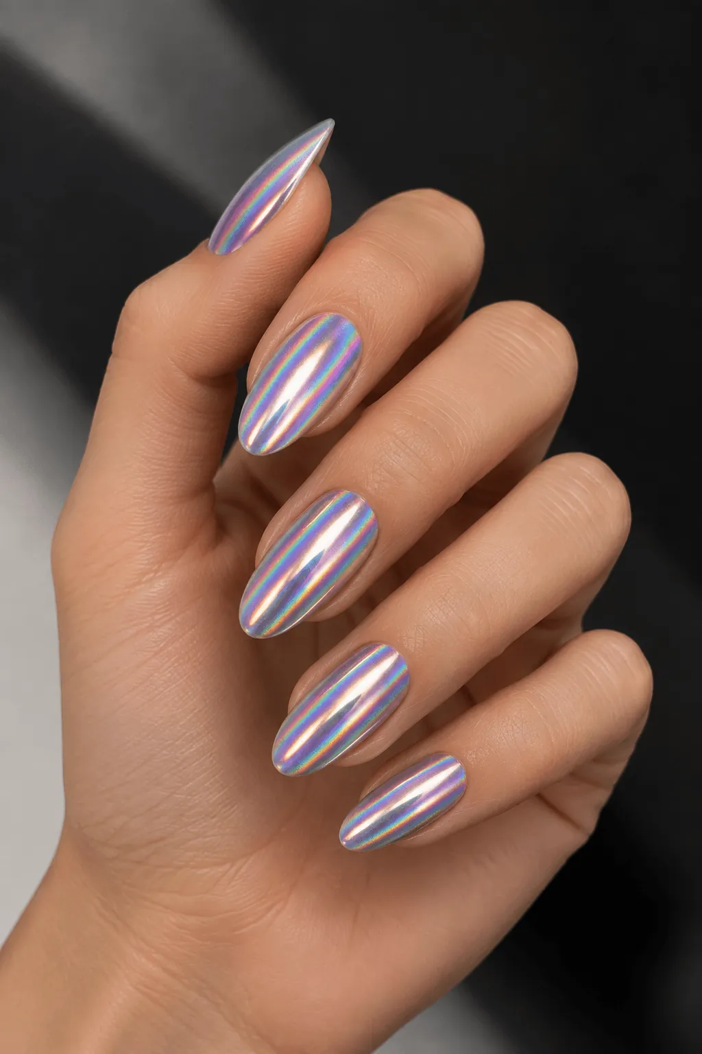 Holographic Chrome Nail Ideas Holographic chrome nails with a rainbow shimmer on almond nails
