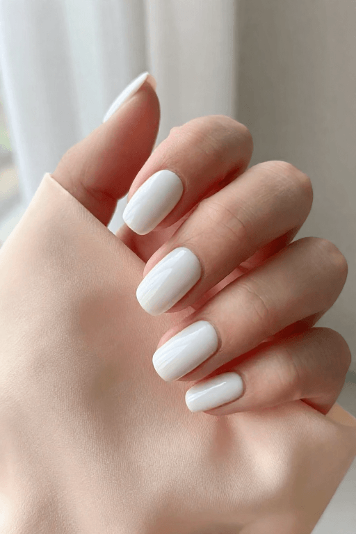 Almond nails in classic milky white polish with a soft glow