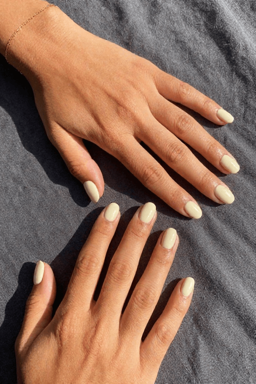 Almond nails in creamy ivory polish on medium skin