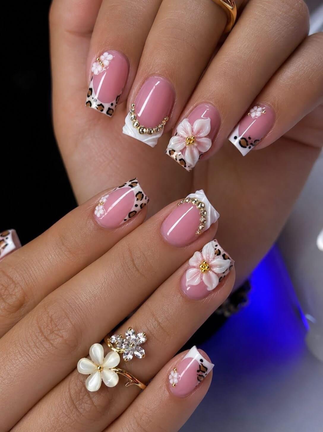 Leopard Print Tips on Pink Nails: Short square glossy pink nails with white tips and brown leopard spots
