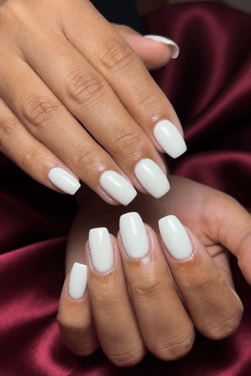 Milky white nails with a thick glossy top coat and glass-like shine
