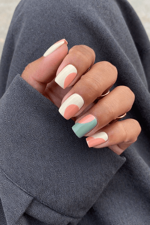 Mismatched Abstract Shapes: Medium square nails in cream, peach, and sage with mismatched abstract arches and half circles