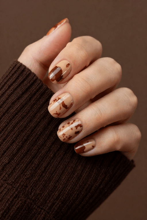 Plastic Wrap Texture Plastic Wrap Texture: Medium almond nails with a rippled marble-like texture in cream and brown
