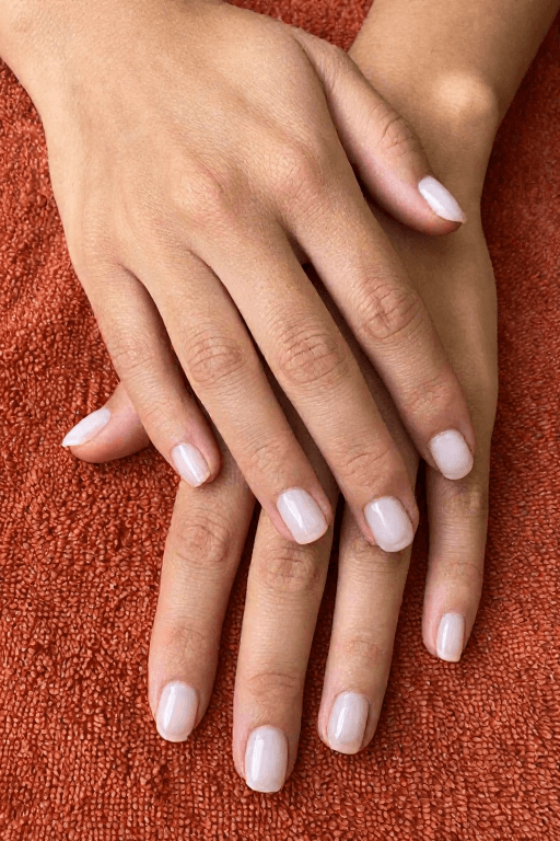 Short nails in sheer milky white that shows the natural nail