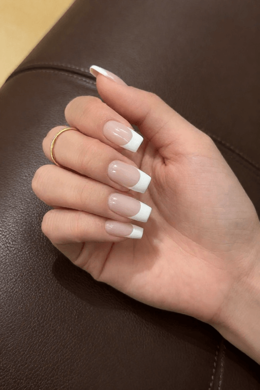 Sheer nude nails layered with a thin coat of white