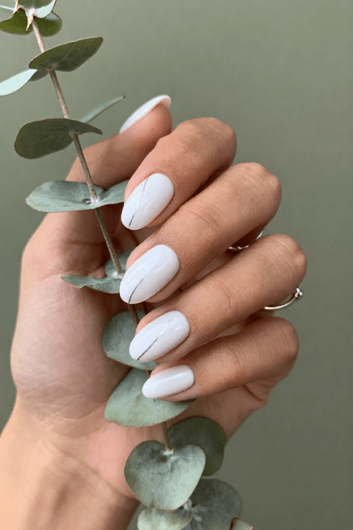 White nails with one thin silver line across the nail