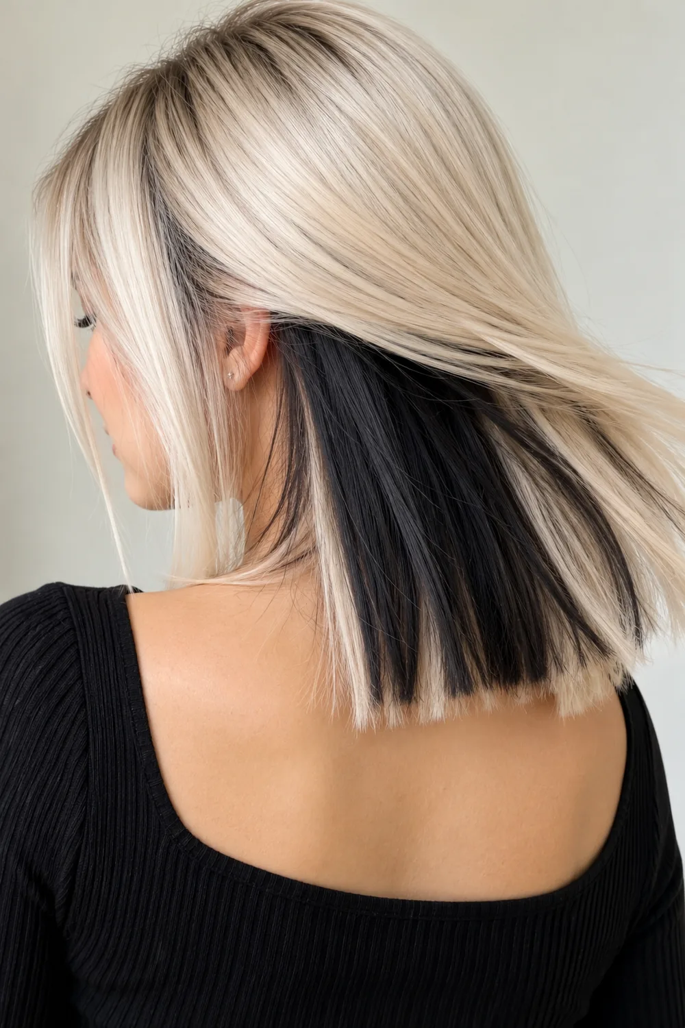 Black peekaboo hair color under platinum blonde hair