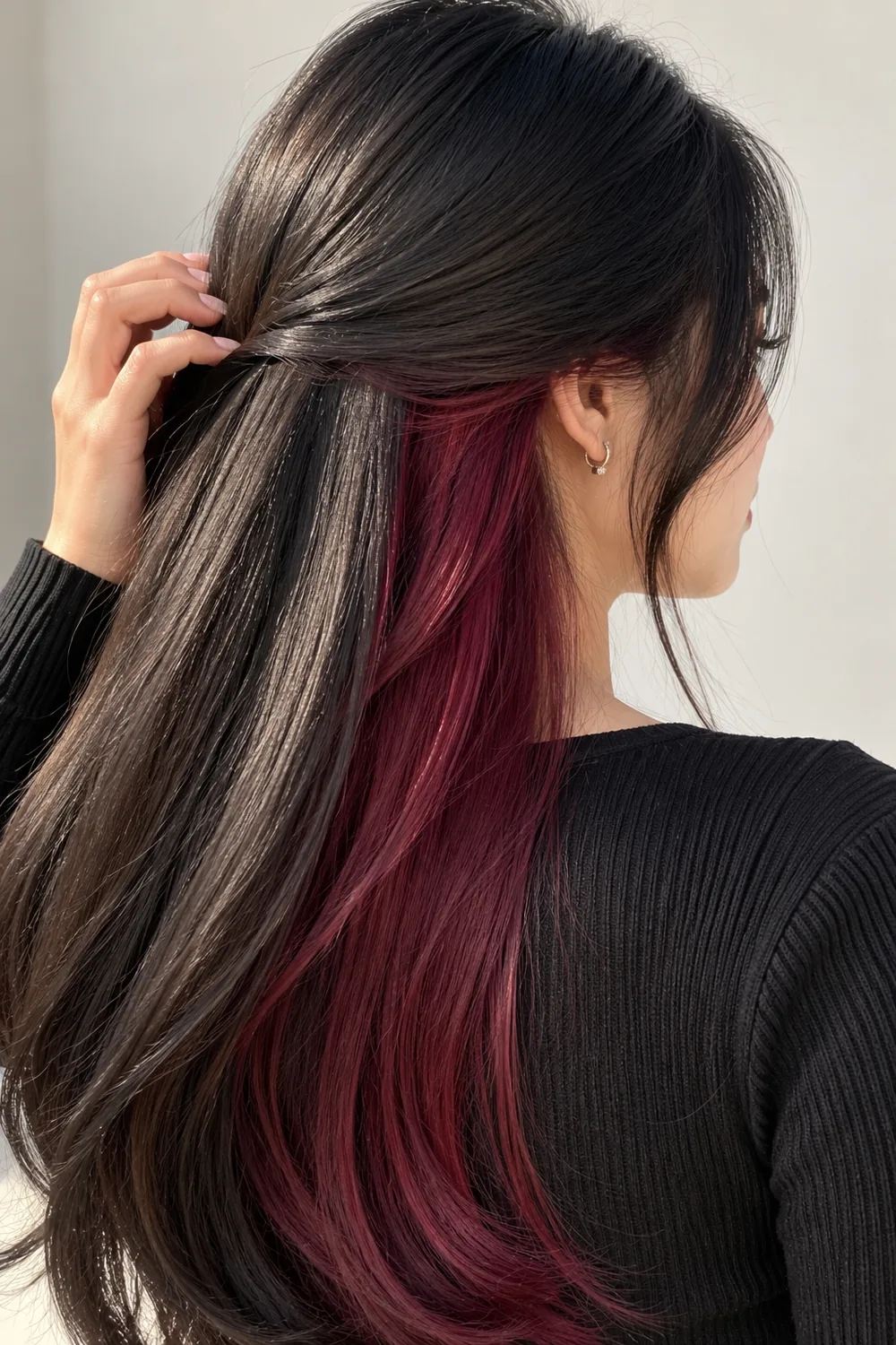 Burgundy maroon peekaboo highlights on black hair