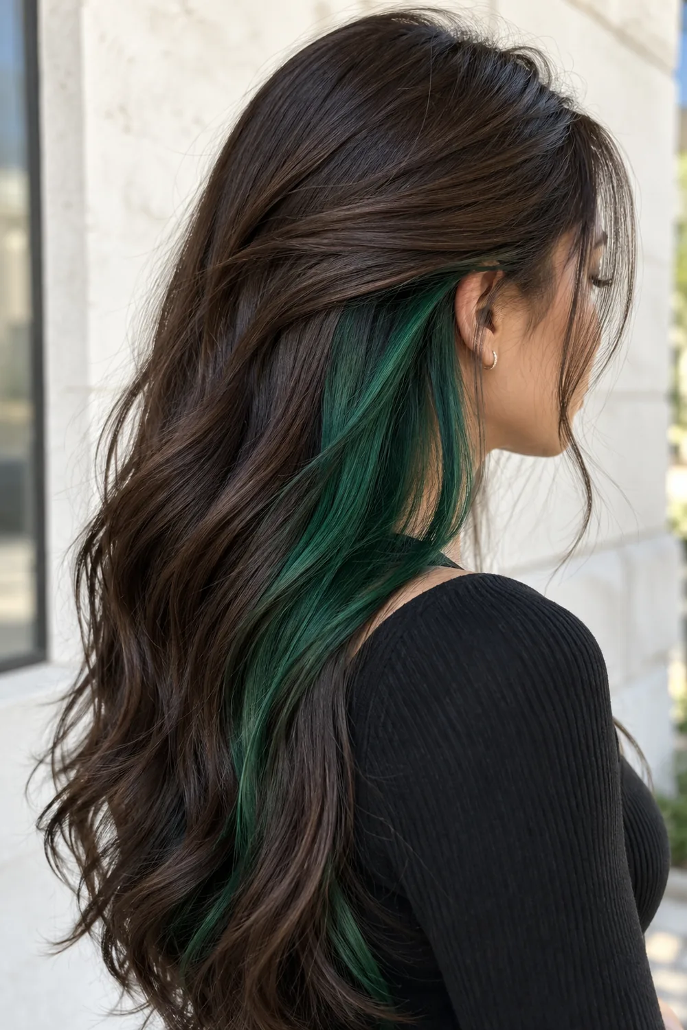 Emerald green peekaboo hair under dark brown hair