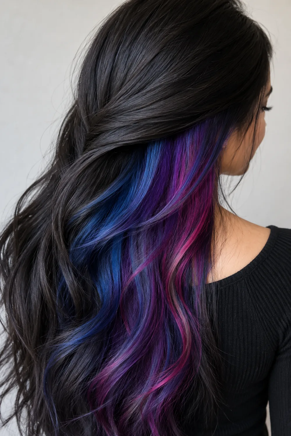 Galaxy peekaboo hair with blue, purple, and pink under dark hair
