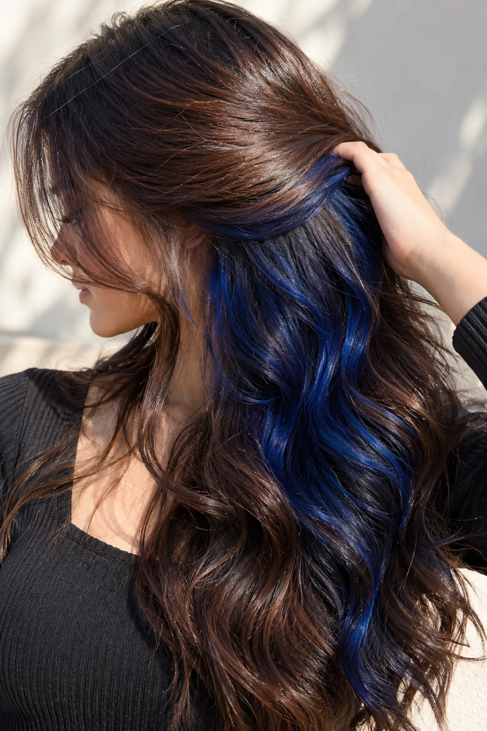 Navy blue peekaboo highlights hidden under dark brown hair