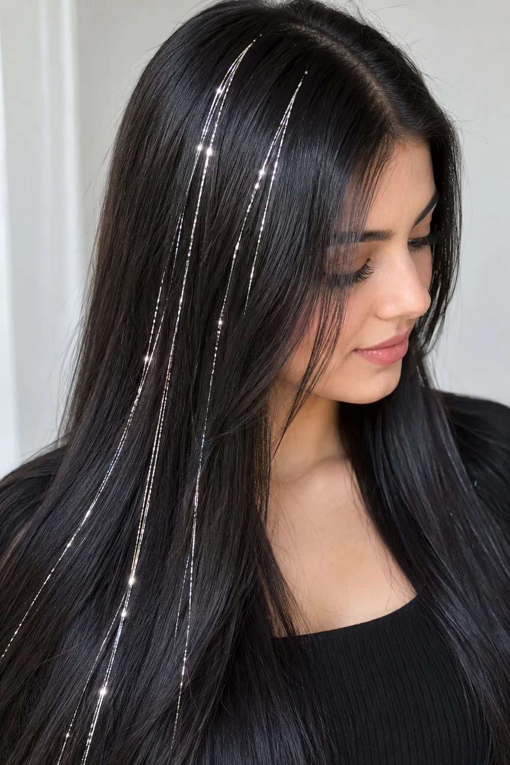 Silver hair tinsel shining against straight black hair